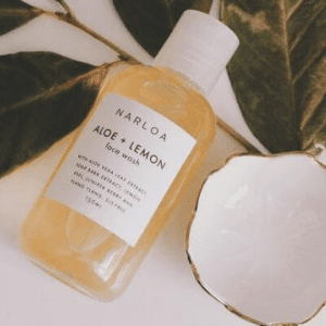 narloa, bottle of narloa skincare oil displayed next to a plant, vegan made in uk skincare