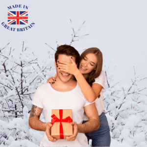 british made christmas gifts, uk christmas gifts, buy chritmas gifts uk, chrismas gift shop uk, man recieving a surprise gift with woman covering his eyes in snowy background