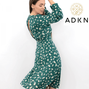 woman wearing a uk made ADKN slow fashion green dress. best british womens clothes