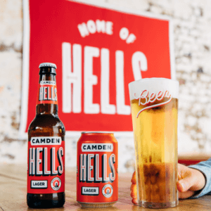 Camden Hells London lager bottles and cans next to a glass of lager