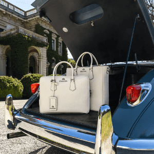 church's luxury leather handbags in boot of a vintage luxury car, british luxury brands